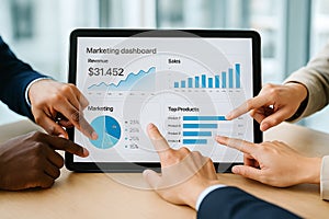 Diverse hands analyzing digital dashboard on tablet in office