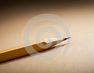 Sharp Yellow Pencil with Freshly Sharpened Tip on Smooth Surface
