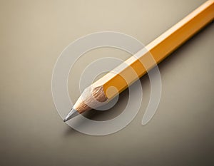 Sharp Yellow Pencil with Freshly Sharpened Tip on Smooth Surface