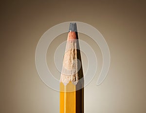 Sharp Yellow Pencil with Freshly Sharpened Tip on Smooth Surface