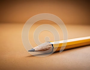 Sharp Yellow Pencil with Freshly Sharpened Tip on Smooth Surface