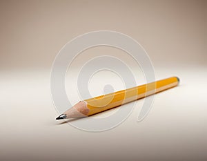 Sharp Yellow Pencil with Freshly Sharpened Tip on Smooth Surface