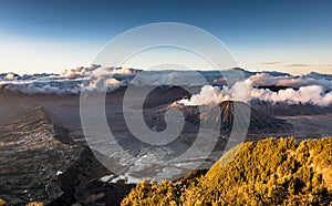 High resolution image of magnificent Mount Bromo volcano with smoke eruption and cloudy background