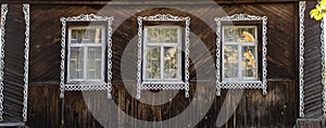 High resolution panorama. Facade of a village house with three windows and platbands