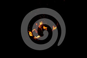 High resolution photo of flame and sparkl on black background. fire flames. Background Texture. Elemen for design abstract of