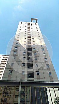 high rise apartment building against a bright blue sky in the background?