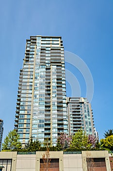 High rise apartment building in Vancouver on blue sky background