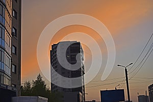 High-rise building in the evening against the blue sky