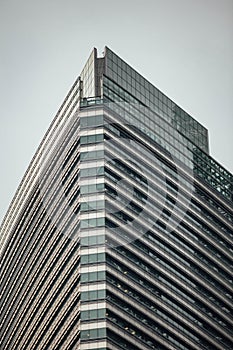 High-rise building facade with glass ans steel near Petronas twin towers in Kuala Lumpur, Malaysia
