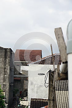 A high-rise building in a housing estate in a city with various types of architecture and a cloudy blue sky background. Perfect fo