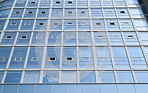 High-rise building made of glass from the outside. Facade of business center, close-up. Exterior of modern office