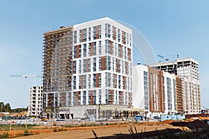 High-rise building under construction. Concept of modern multi-apartment housing in a new neighborhood