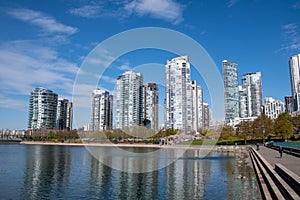 High rise buildings reflected on the surface of the False Creek .