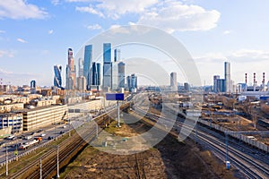 High-rise buildings and transport metropolis, traffic and blurry lights of cars on multi-lane highways and road junction