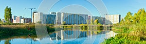 High-rise buildings under construction are reflected in the river