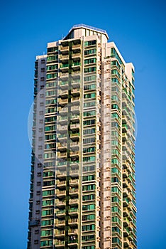 High rise condominium building against blue sky background