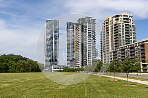 High-rise condominiums - green park - blue sky - sunny day