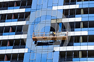 High-rise construction. Installation of a high-rise building. Concrete, steel, glass and man together