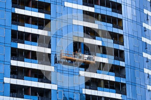 High-rise construction. Installation of a high-rise building. Concrete, steel, glass and man together