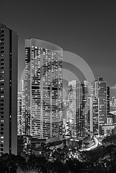 High rise modern office building in Hong Kong city at night in monochrome