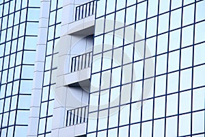 A high-rise office building with blue glass windows