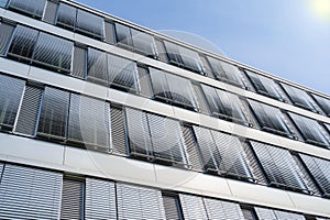 High-rise office building facade with covered windows Venetian b