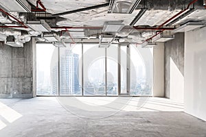 High rise office under construction with open ceiling to see structure and system work, glass windows for take aerial view.