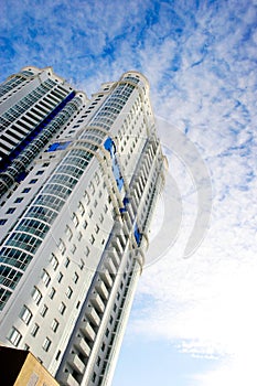 High-rise and residential building on sky background