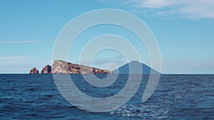 High rock and mountain in Mediterranean sea. Horizon, blue sky. Lipari Islands, Sicily, Italy