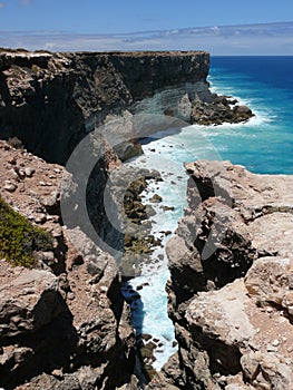 High rocky coast with surf.