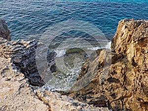 High rocky mediterranean shore and transparent blue water