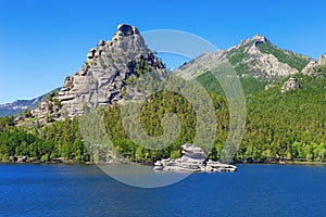 High scaur Okzhetpes and mysterious sphinx Zhumbaktas puzzle-stone on Lake Auliekol Borovoe photo