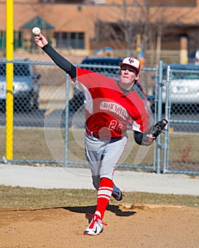 High school baseball pitcher warms up