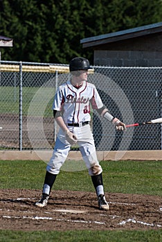 A high school baseball player up to bat.