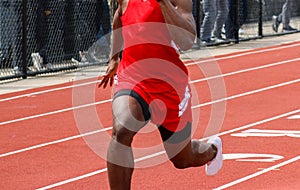 High school boy running fast in the 100 meter dash