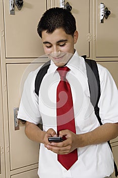 High School Boy Text Messaging By School Lockers