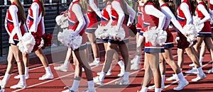 High school cheerleaders perfoming during football game