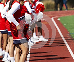 Cheerleaders on the track during a football game