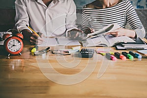 High school or college Asian student group sitting at desk in class studying and reading, doing homework and lesson practice