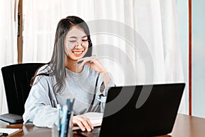 High school or college student learning tutoring on desk and reading, doing homework, lesson practice preparing exam on laptop at