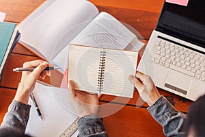 High school or college students  group catching up workbook and learning tutoring on desk and reading, doing homework, lesson