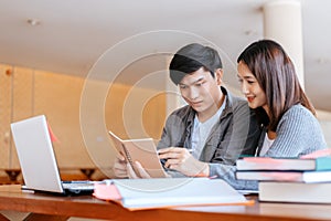 High school or college students  group catching up workbook and learning tutoring on desk and reading, doing homework, lesson