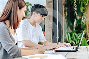 High school or college students  group catching up workbook and learning tutoring on desk and reading, doing homework, lesson