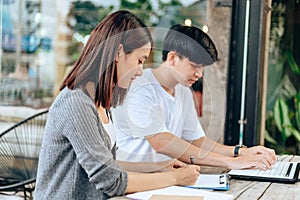 High school or college students  group catching up workbook and learning tutoring on desk and reading, doing homework, lesson