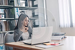 High school or college students studying and reading text on laptop