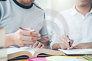 High school or college students studying and reading together in