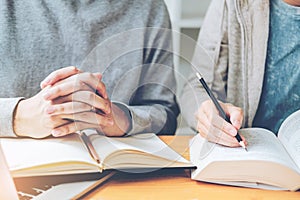 High school or college students studying and reading together in