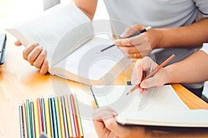 High school or college students studying and reading together in library