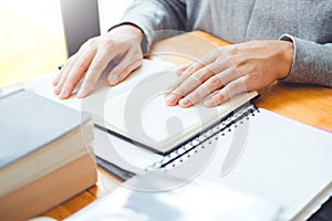 High school or college students studying and reading together in library