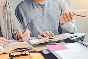 High school or college students studying and reading together in library